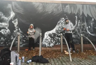 Seán Montayne creating a mural with artist Shane Sutton 