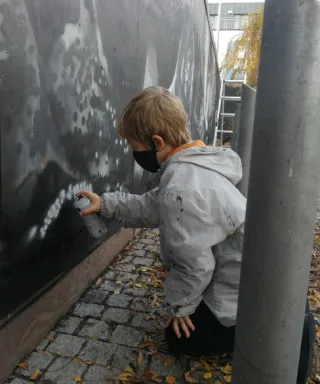 Seán Montayne creating a mural with artist Shane Sutton 