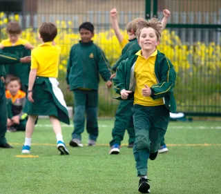 Boy running on all weather pitch